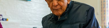 older man holding a mug